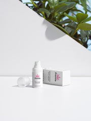 White bottle and box with 'Premia' branding on a white background with greenery.